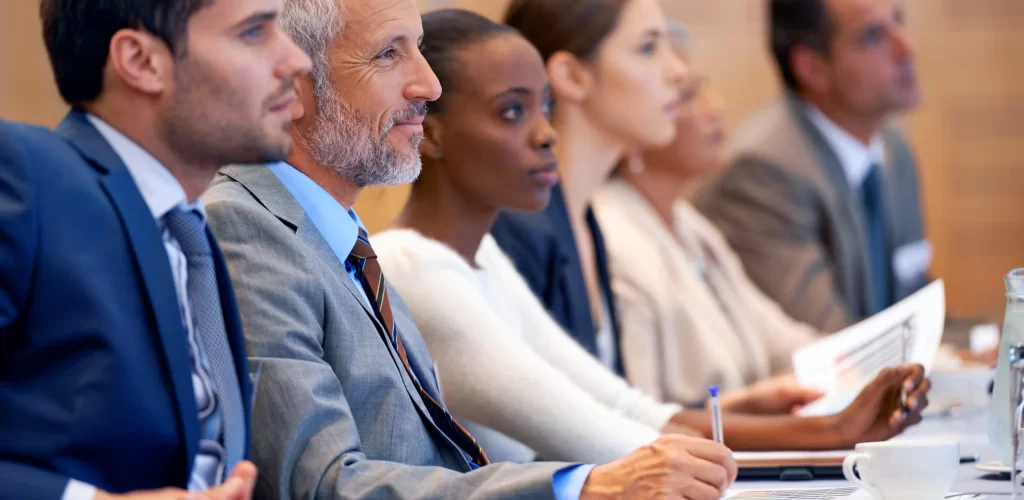 Shot of a group of people sitting in a conference.